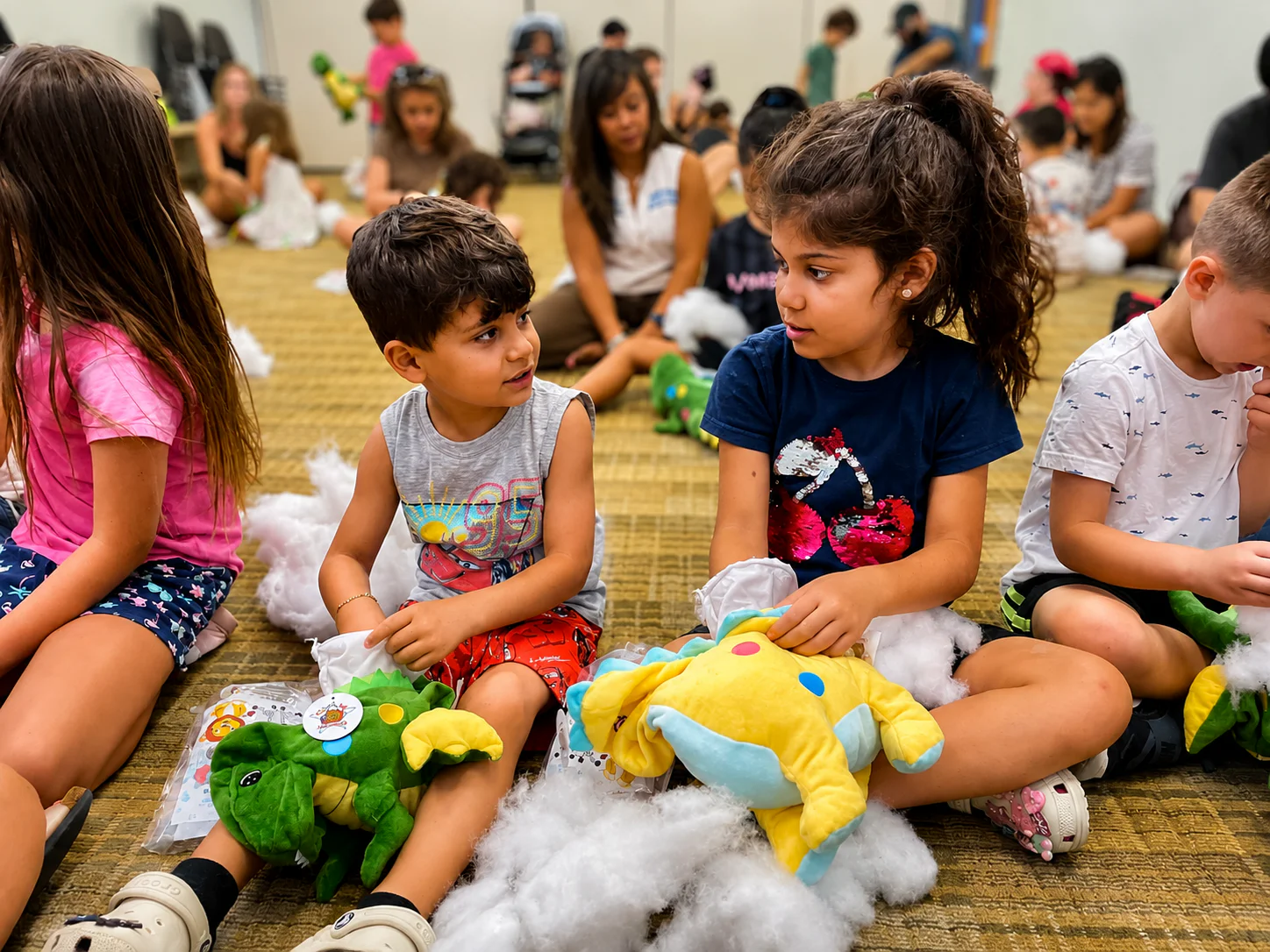Children participating in a stuffed animal workshop together