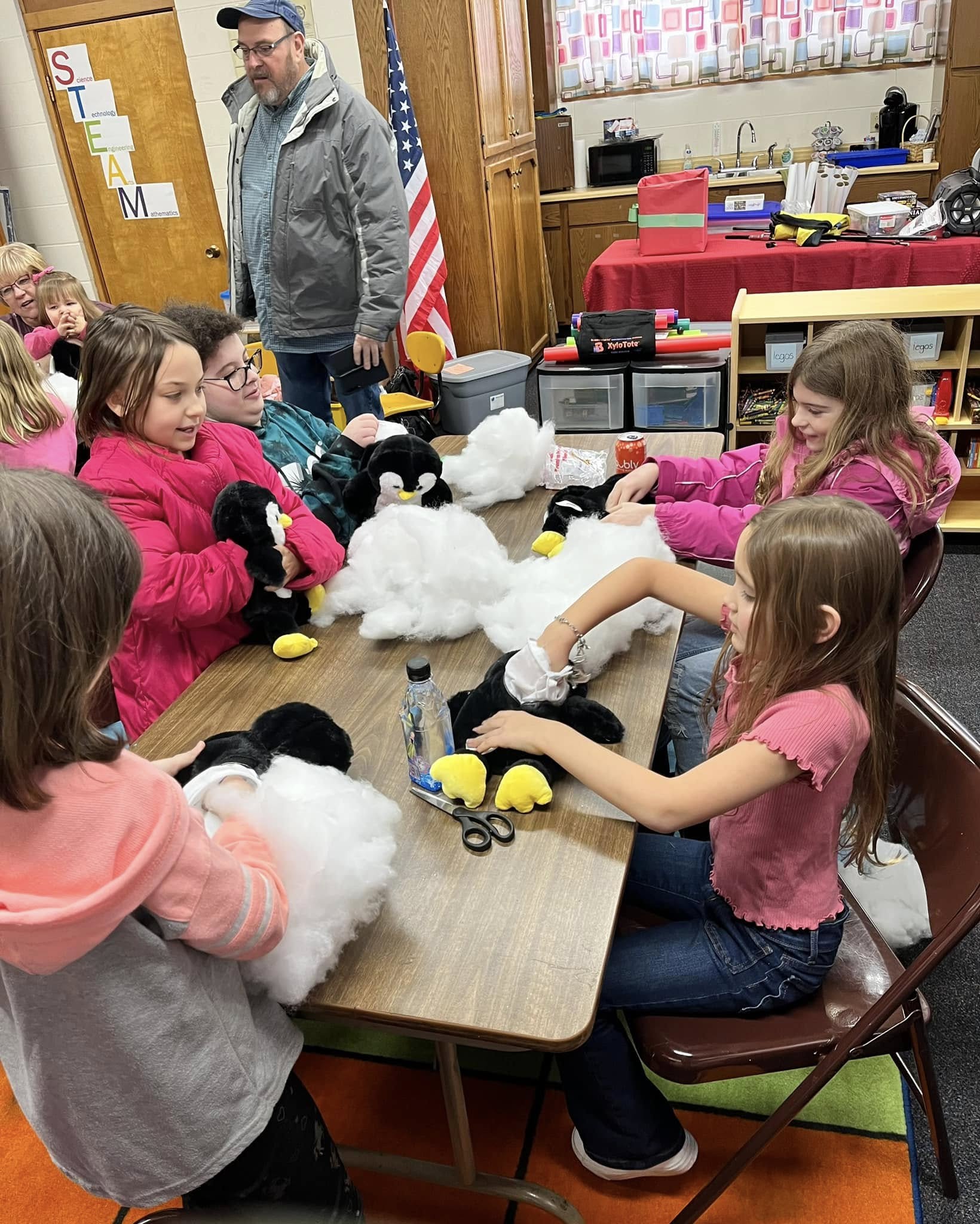 A library workshop event with kids holding their finished Furry Friends