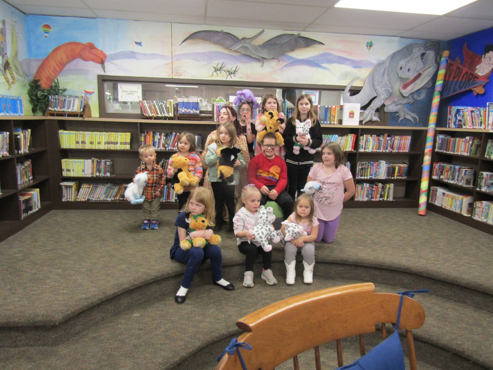 A group of children sitting together and hand-stuffing their Furry Friends at a library workshop
