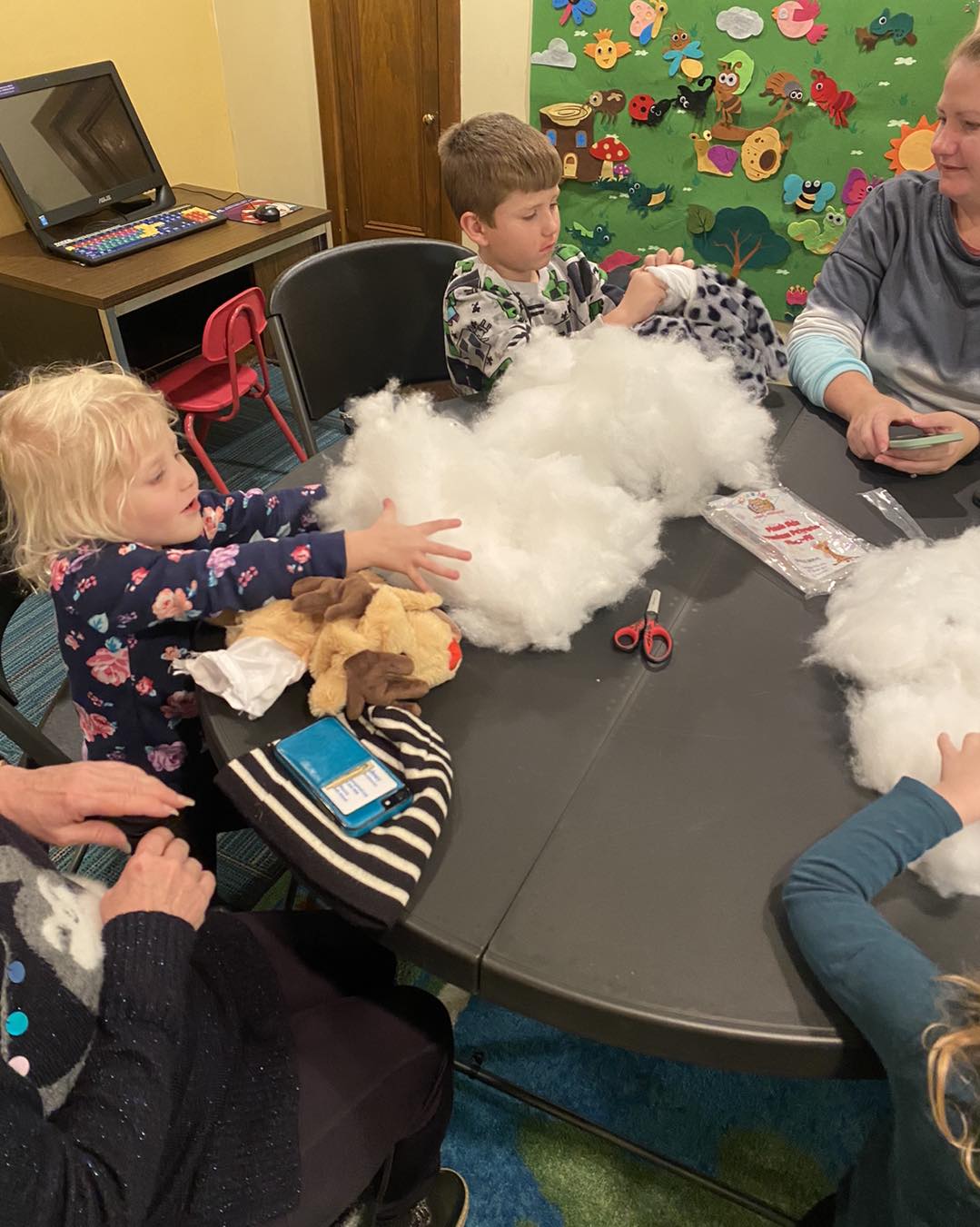 Kids comparing the furry friends they each built at the workshop