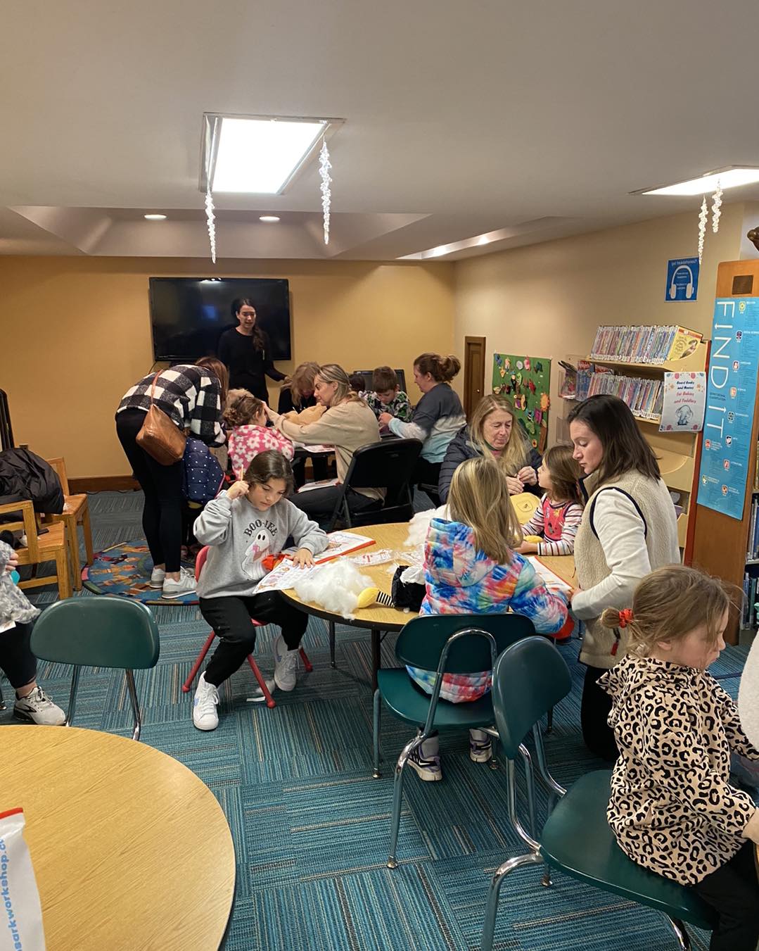 Children holding their finished Furry Friends at a library workshop